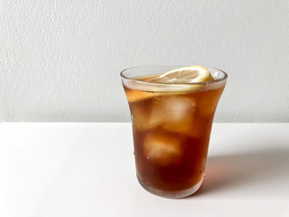 Iced pouring light roasted coffee, topped with lemon.