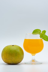 Orange juice in glass and organic orange