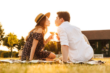 Loving couple sitting by dating kissing.