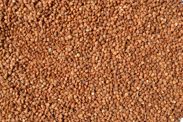 Uncooked Buckwheat laid out on a table is used as a background or decoration element.