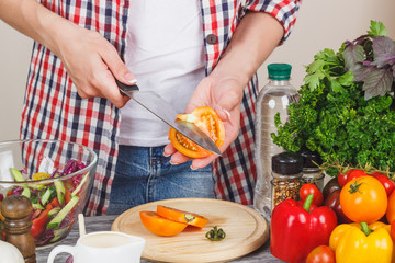 Woman cooks at the kitchen