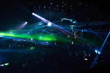 Fototapeta na wymiar Defocused entertainment concert lighting on stage, blurred disco party.