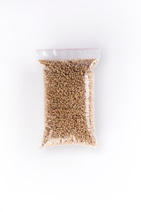 Flat lay view of beans in transparent package on white background.