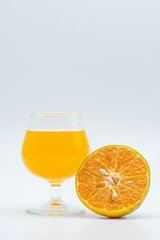 Close up glass of orange juice with sliced orange