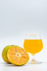 Close up glass of orange juice with sliced orange