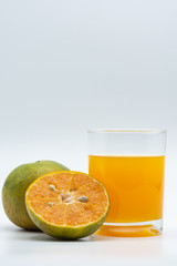 Close up glass of orange juice with sliced orange