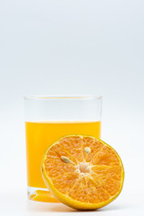 Close up glass of orange juice with sliced orange