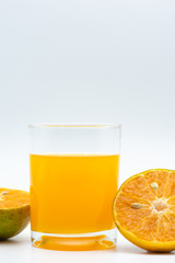Close up glass of orange juice with sliced orange