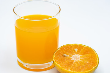 Close up glass of orange juice with sliced orange