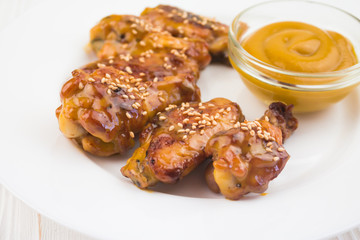 chicken wings and mustard sauce, in a plate