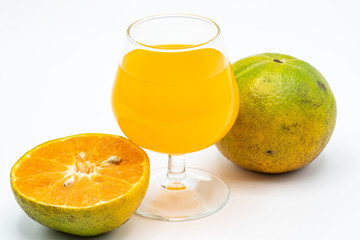 Close up glass of orange juice with sliced orange