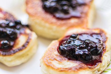 Pancakes are sprinkled with berry jam.