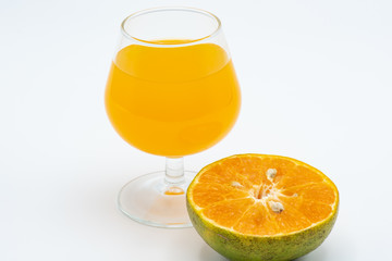 Close up glass of orange juice with sliced orange