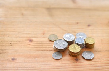 Malaysian Coins on wooden table. selective focus.