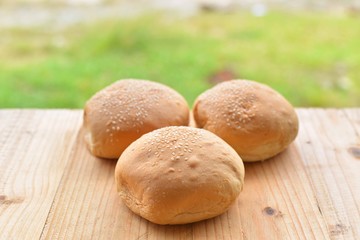 burger buns on wooden table.