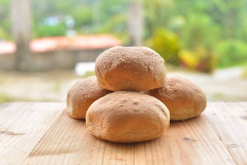 burger buns on wooden table.