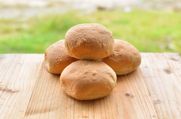 burger buns on wooden table.