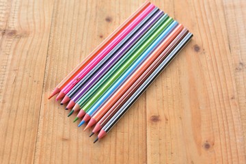 colourful color pencils on wooden table.