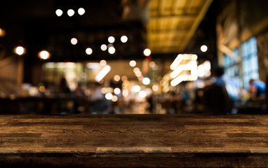 Real wood table with appetizer and light reflection on scene at restaurant, pub or bar at night.