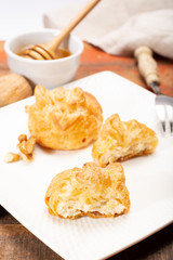 French snack pouches made from puff pastry with fresh soft goat cheese and honing