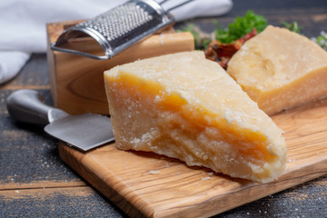Traditional italian food - 36 months aged in caves Italian parmesan hard cheese from Parmigiano-Reggiano, Italy