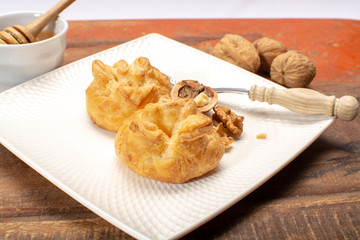 French snack pouches made from puff pastry with fresh soft goat cheese and honing