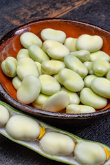 New harvest of healthy vegetables, green fresh raw big broad beans close up
