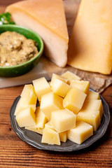 Famous Dutch finger food usually served with glass of beer, cubes hard old Dutch cow and goat cheese with Dijon mustard