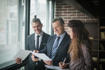 business partners discussing business documents standing in the 