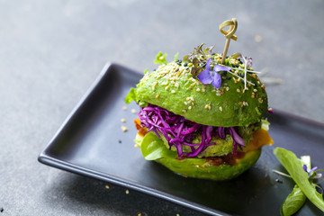 Avocado sandwich with green vegan burger,  roast yellow pepper and pickled red cabbage - obrazy, fototapety, plakaty