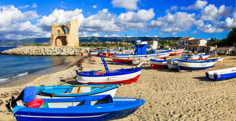 Traditional fishing village Briatico in Calabria with colorful boats and old saracen tower. Italy