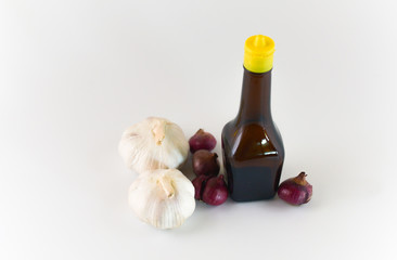 empty seasoning glass bottle with garlic and onion isolated on white background. selective focus.