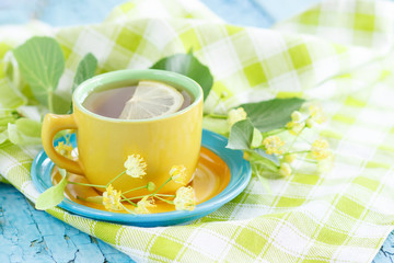 Cup of herbal tea with linden blossoms and lemon