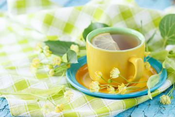 Cup of herbal tea with linden blossoms and lemon