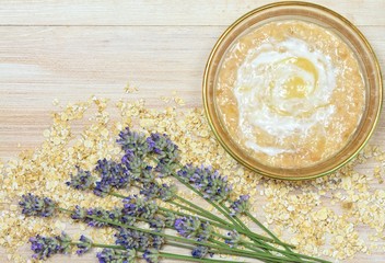 Face mask from oatmeal, yogurt, banana, honey / Mixed face mask in bowl, copy space and lavender 
