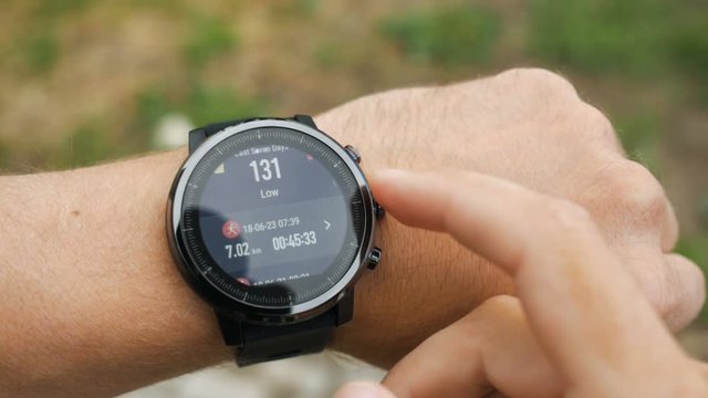 Results of a running training session on smart watch. Smartwatch. Hand with sports watch which shows results of training. Pulse, speed, distance, calories