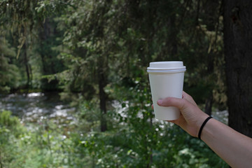 cup coffee in hand outdoors