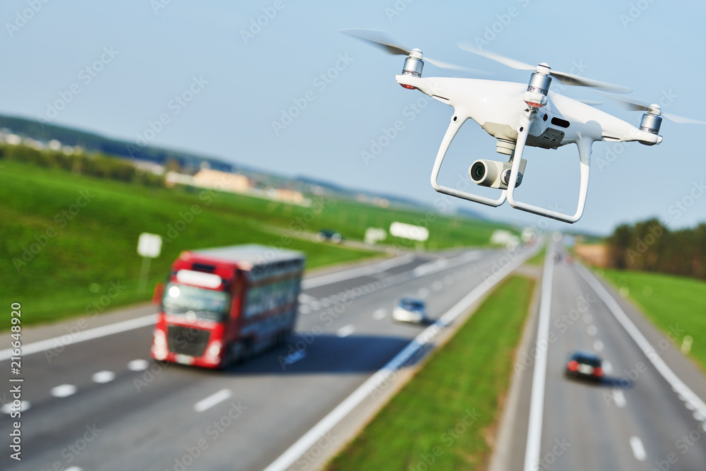 Wall mural drone and transportation. drone with camera controls highway road conditions