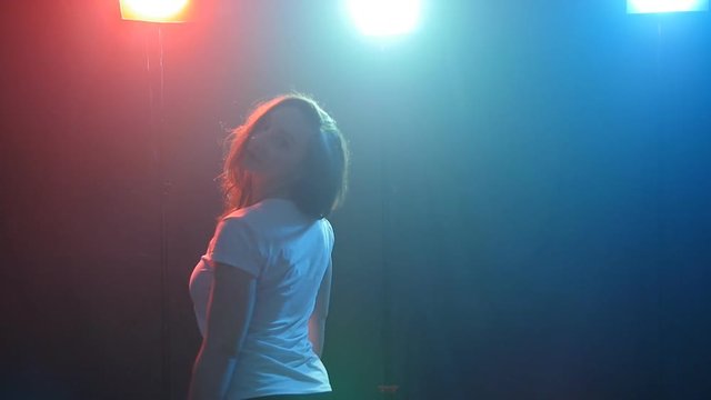 Young girl dancing in color light
