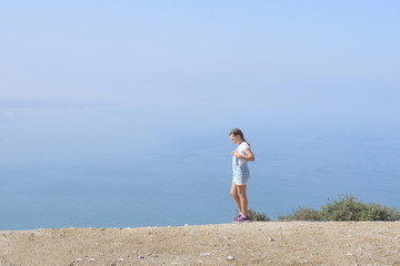teen girl walking on top of mountain