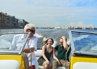 A young couple is traveling on a speedboat.