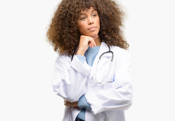 African american doctor woman, medical professional working thinking and looking up expressing...