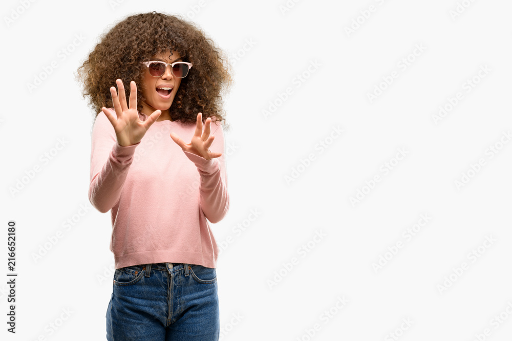 Poster african american woman wearing pink sunglasses afraid and terrified with fear expression stop gestur