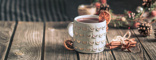 mulled wine in a cup on a wooden background