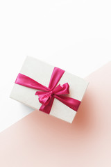 Gift Box with Red Ribbon on Pink Background
