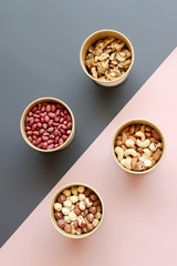 Walnut, Peanuts, Hazelnuts, Cashews in Boxes on a Combined Background