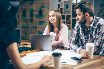 Group of young people preparing for the seminar in a cafe