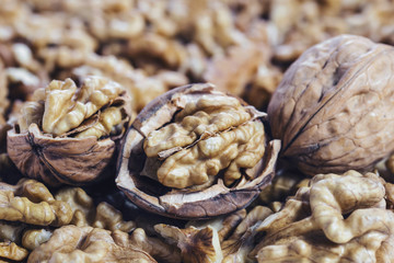 chopped and whole walnuts lie in one pile creating a beautiful background.