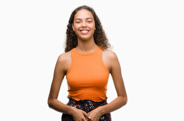 Young hispanic woman with a happy face standing and smiling with a confident smile showing teeth