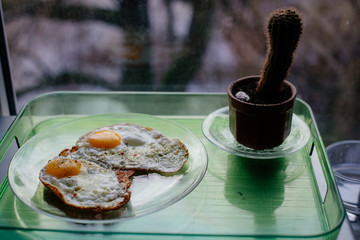 Fried eggs for breakfast early in the morning. Scrambled eggs with spices.
